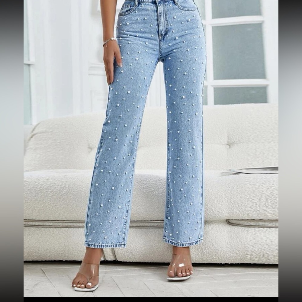 Worn once, light wash jeans with pearls down the front perfect for bridal events